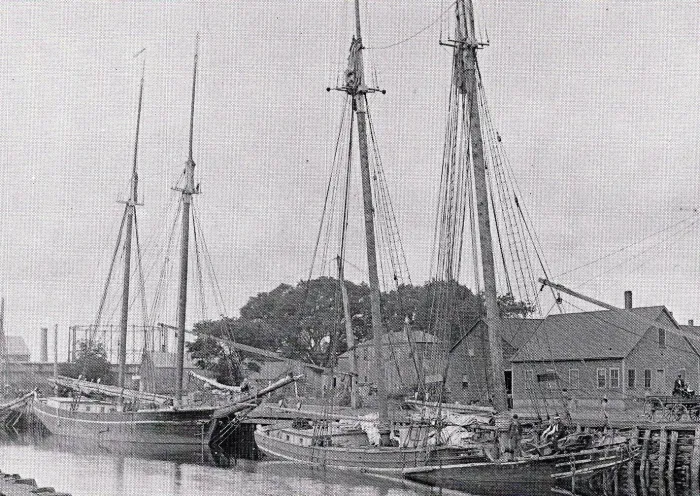 Historic photograph of sailing ships docked on the Taunton River